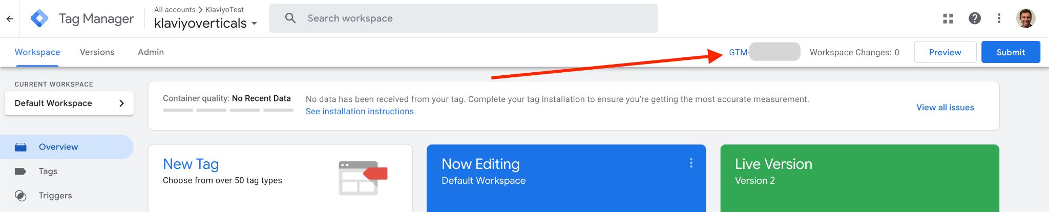 Google Tag Manager workspace with an orange arrow pointing to the GTM container ID.