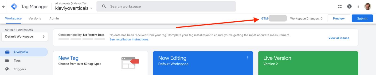 Google Tag Manager workspace with an orange arrow pointing to the GTM container ID.