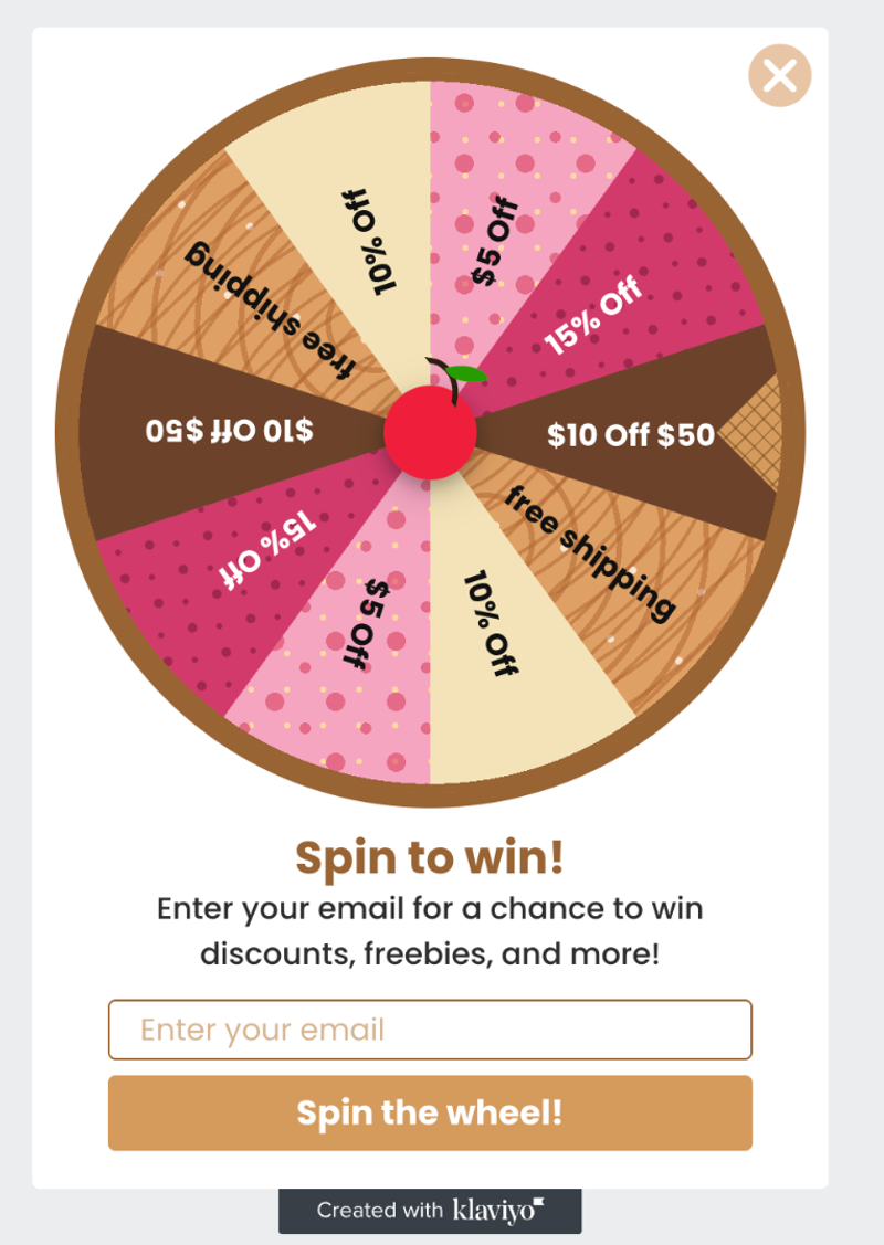 Pop-up window with a spin-to-win discount wheel, featuring various discounts like 10% off, $5 off, 15% off, $10 off $50, and free shipping, with an email input field and "Spin the wheel!" button.