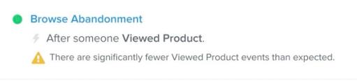 Name of a flow in the flows list view with a warning about a drop in activity displayed below it.