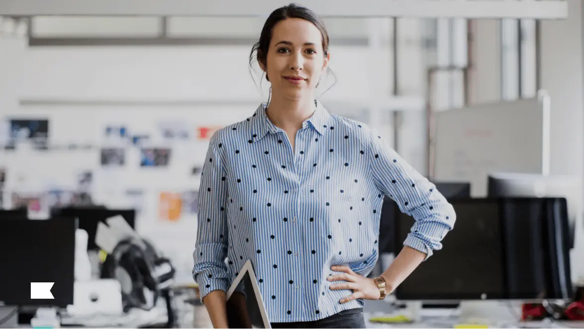 Person standing with hand on hip in an office