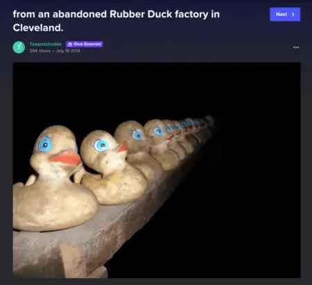 Image shows a screenshot of a creepy photo subscribers land on when they click one of the “trick” links in the Minor Figures Halloween marketing email. The photo, titled “abandoned rubber duck factory in Cleveland,” shows a dozen dirty rubber duckies lined up on a wooden shelf in the night.