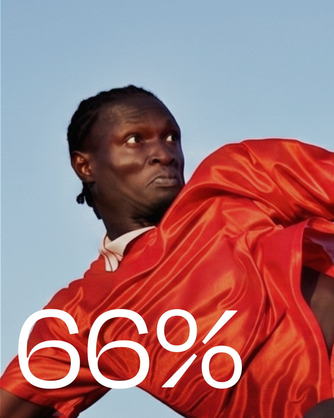 A dark-skinned person with braided hair in a flowing red shirt looks intently to the left against a blue sky, with white text "66%" overlaid.