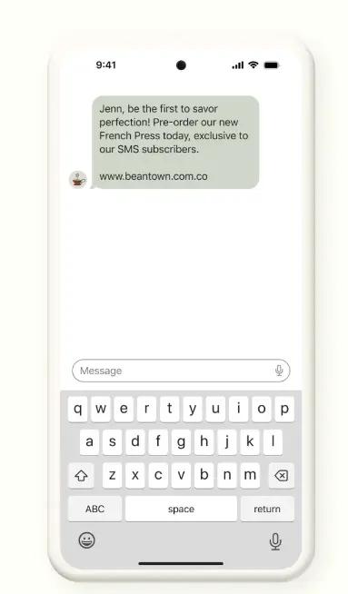 Image shows an AI-generated SMS campaign example announcing a new product. It reads, “Jenn, be the first to savor perfection! Pre-order our new French Press today, exclusive to our SMS subscribers.”