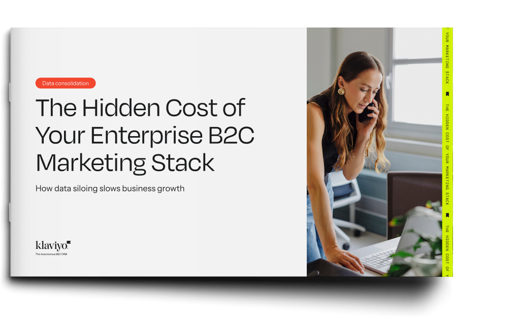 Klaviyo white paper cover: "The Hidden Cost of Your Enterprise B2C Marketing Stack", featuring a woman on the phone looking at a laptop.
