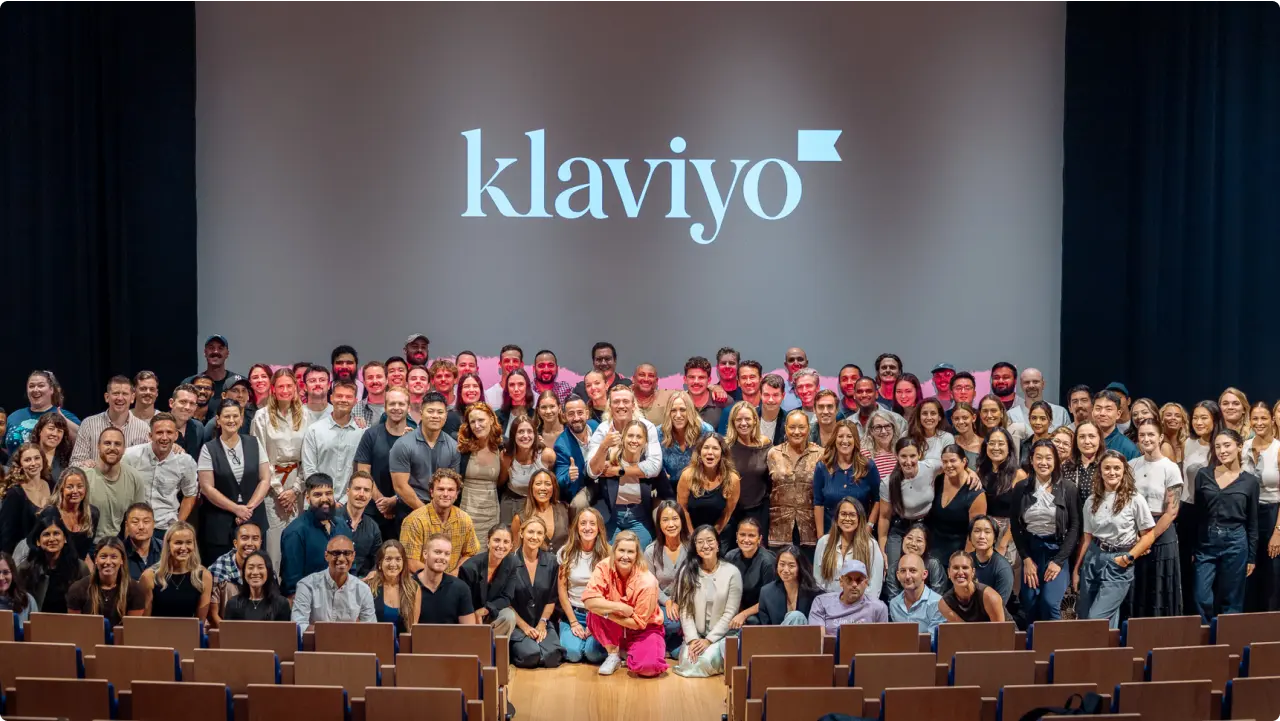 Klaviyo's Sydney team posing for a photo at the front of an auditorium.