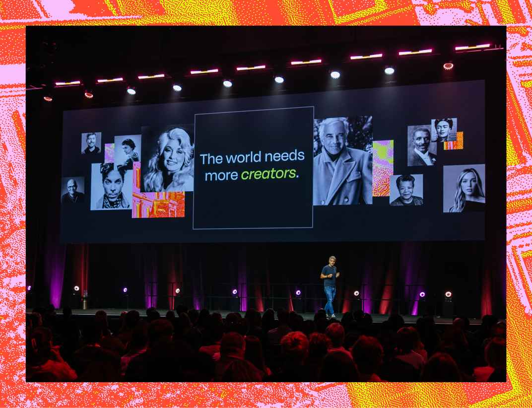 A man presents on a stage to an audience, with a large screen displaying "The world needs more creators" and portraits of various people.