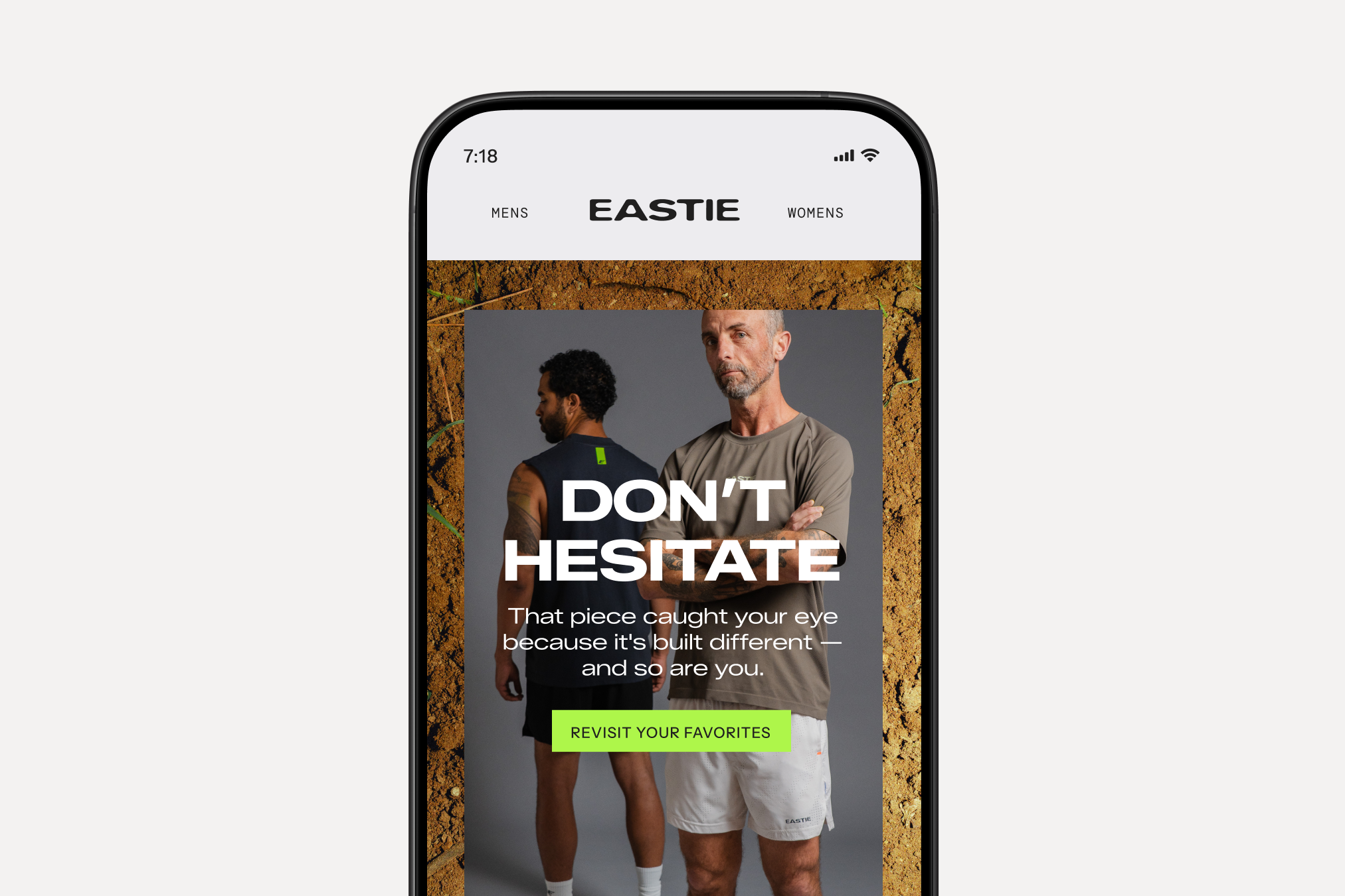 Smartphone displaying an Eastie activewear ad with two male models and a “Revisit Your Favorites” button.