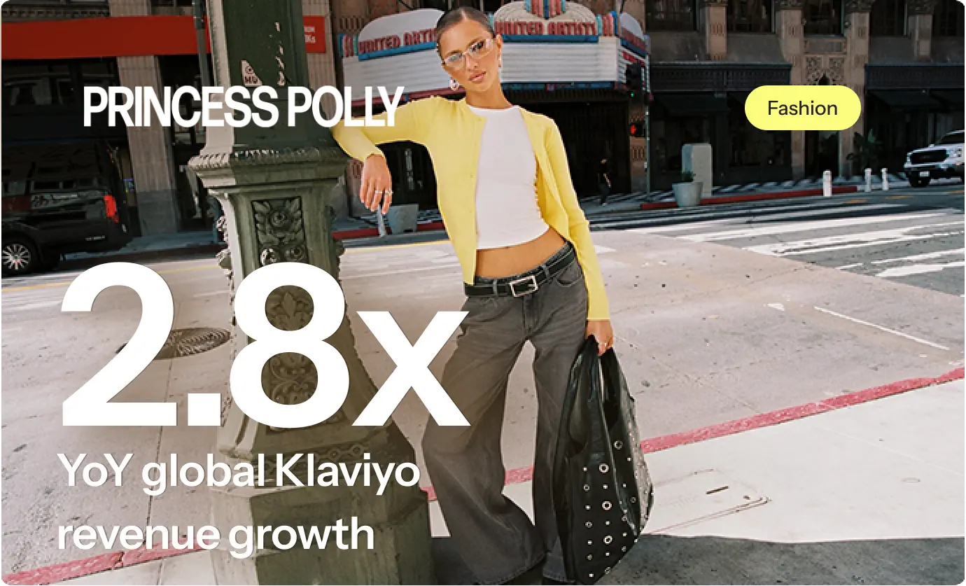 Woman in a yellow cardigan and grey pants stands on a city street holding a black bag. Text: "Princess Polly 2.8x YoY global Klaviyo revenue growth.