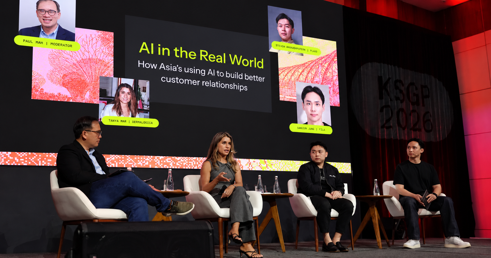 Four panelists on a stage discussing "AI in the Real World," with the KSGP 2026 logo visible in the background.