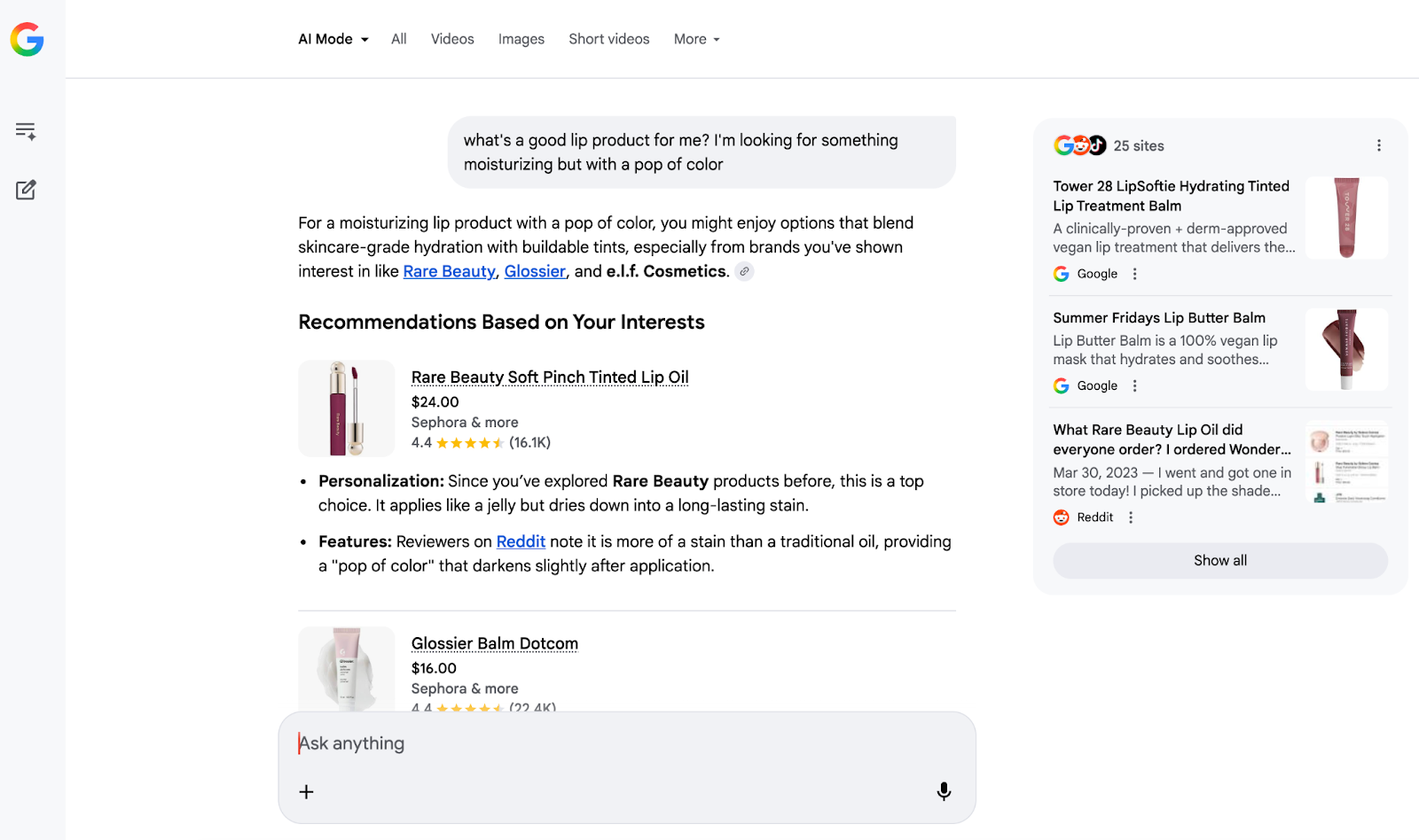 Screenshot of Google AI Mode recommending a Rare Beauty lip oil, based on a conversational prompt and the user’s previous search history. At the top is the prompt, “what’s a good lip product for me? I’m looking for something moisturizing but with a pop of color.” Underneath are two small thumbnail photos of lip color products, the first being a red lip gloss with a shiny silver cap. The one underneath is a pink and white tube of Glossier Balm Dotcom. To the right are additional citations from Google and Reddit, each with their own small thumbnails of dark pink lip gloss tubes.