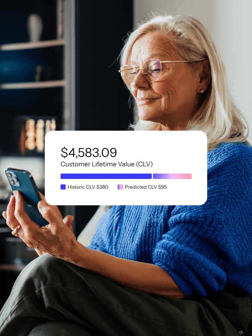 Older woman using a smartphone with a customer lifetime value dashboard overlay.