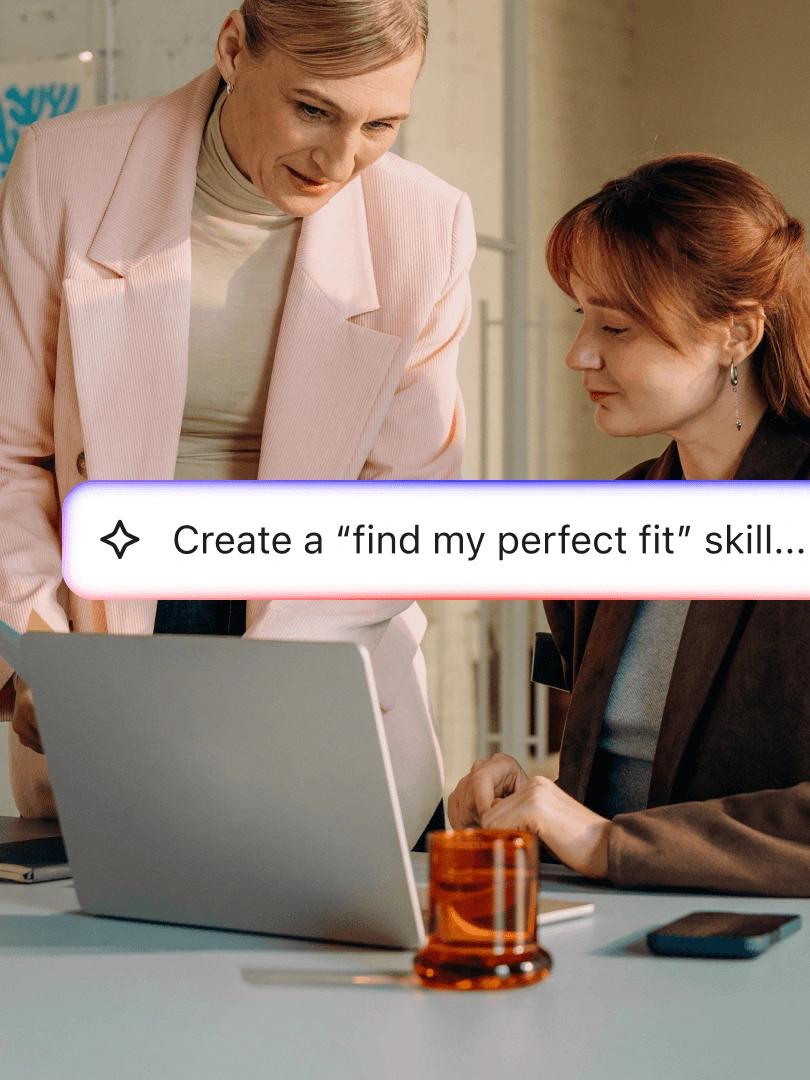 Two women collaborate at a laptop with a prompt reading “Create a ‘find my perfect fit’ skill...”