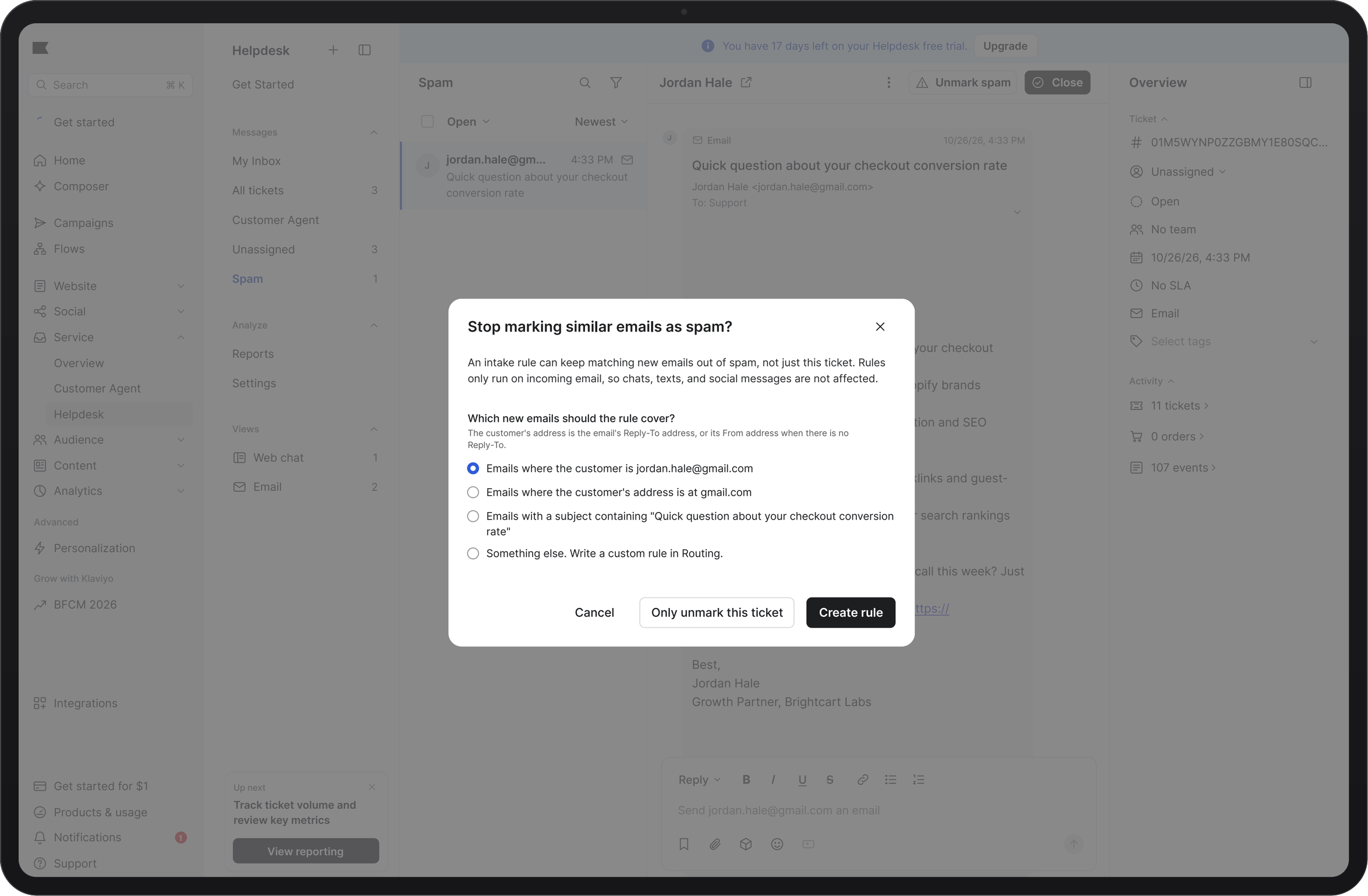 A tablet displaying a helpdesk interface with a modal dialog asking "Stop marking similar emails as spam?", showing options to create a rule, with the sender's email selected.