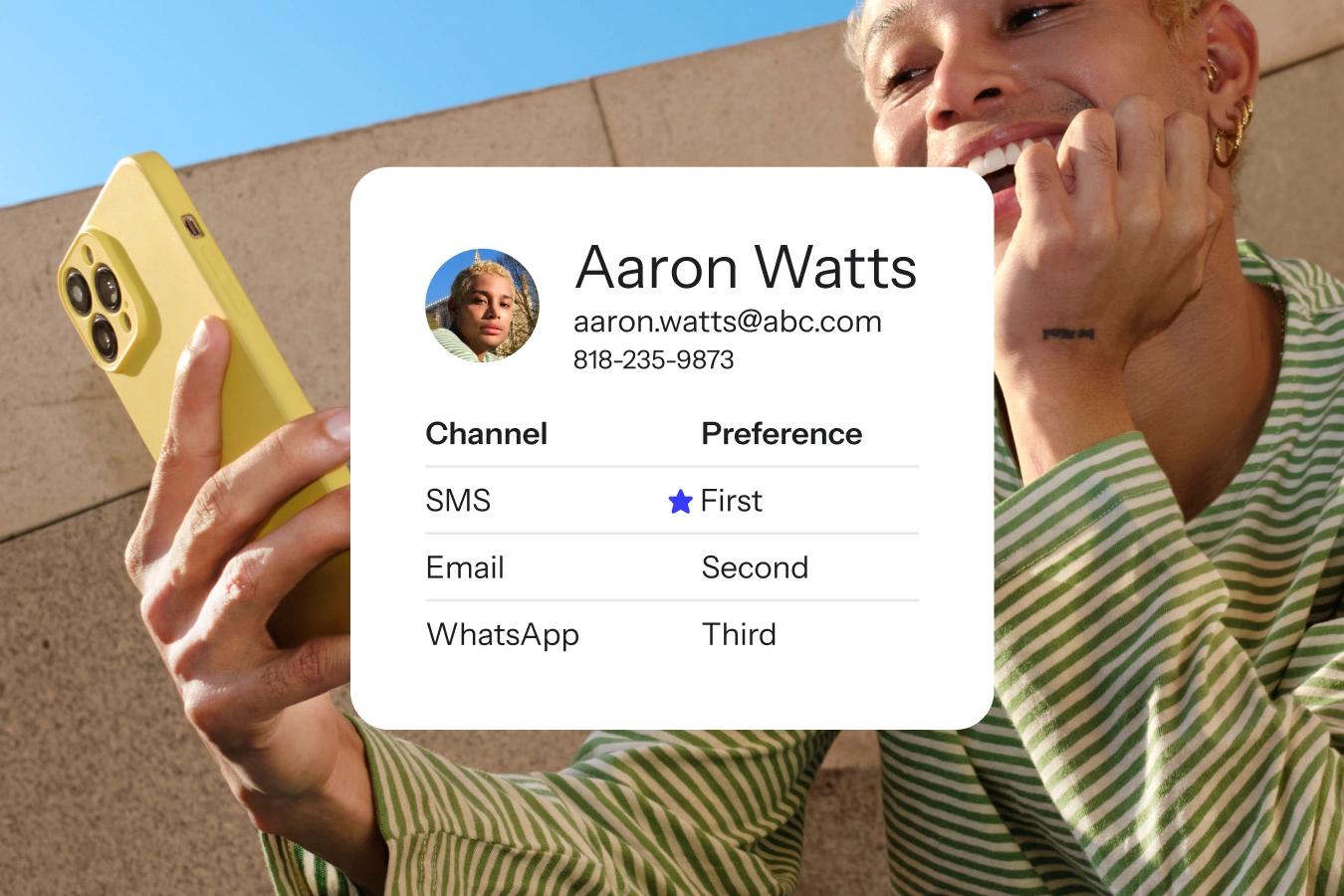 Smiling man holds a phone beside a contact card listing SMS, email, and WhatsApp preferences.