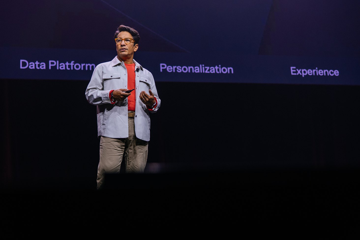 Speaker presents onstage before a screen reading Data Platform, Personalization, and Experience.