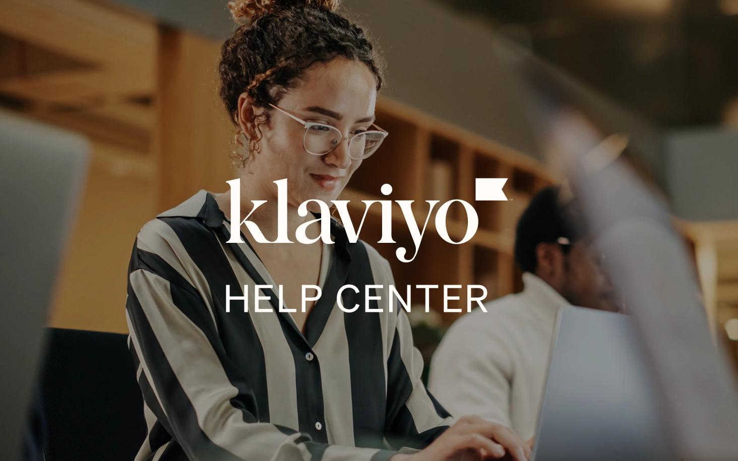 Woman wearing glasses works at a laptop in an office, overlaid with “Klaviyo Help Center” text.