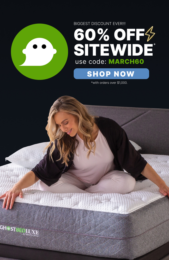 Image shows an email from mattress brand GhostBed featuring a March Madness promotion with "BIGGEST DISCOUNT EVER!!!" and "60% OFF SITEWIDE" in large white text on a black background, alongside their ghost logo in bright green. The email includes a "SHOP NOW" CTA button and shows a person with long blond hair sitting on a GhostBed mattress. The promotion code is MARCH60 for orders over $1,000.