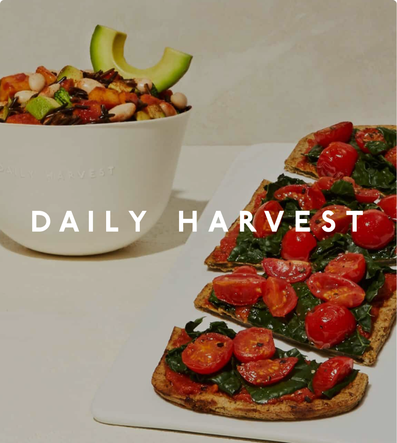 Daily Harvest grain bowl with avocado, and flatbreads topped with tomatoes and greens.