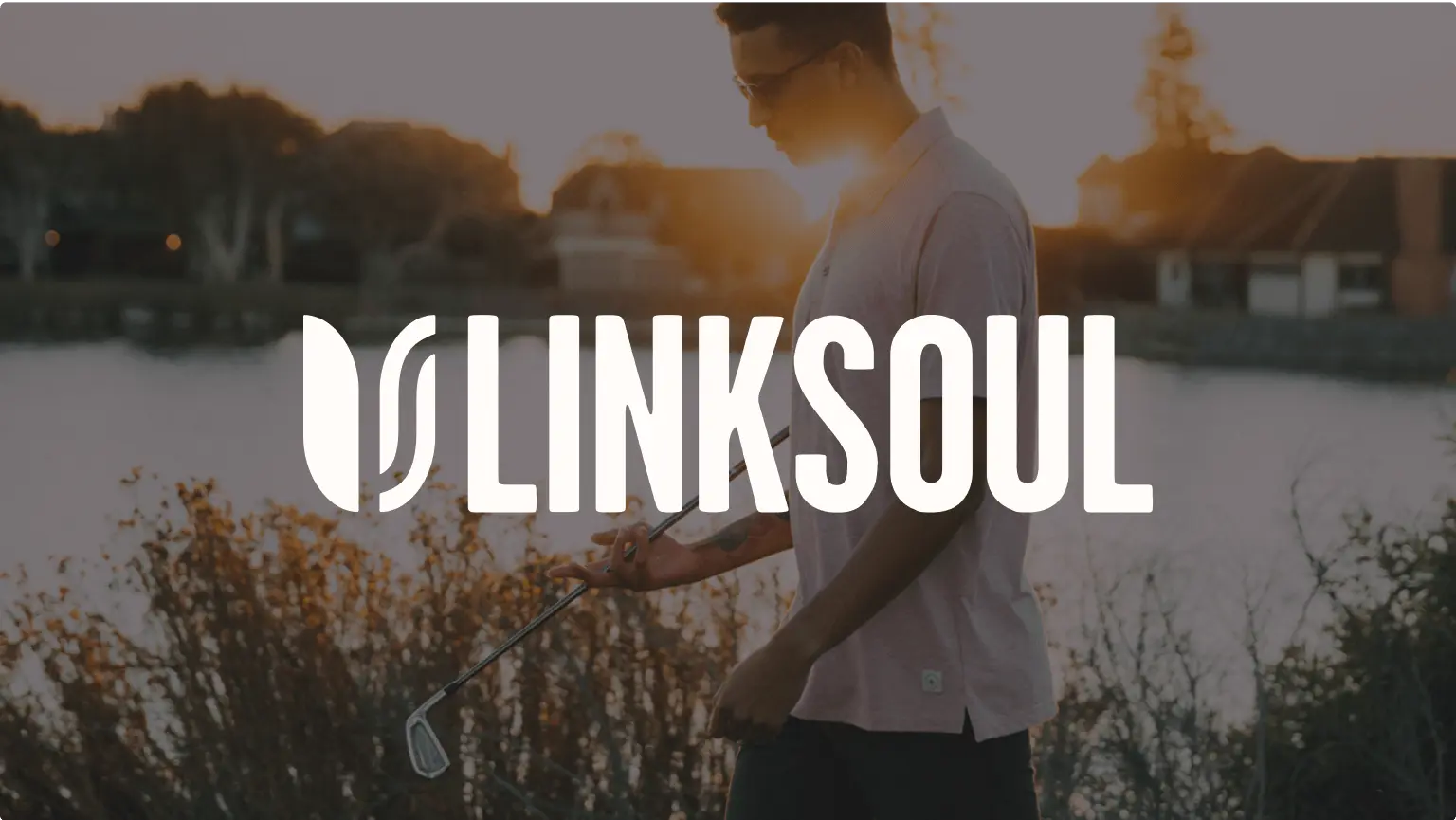 A man walking by a lake with a golf club at sunset, overlaid with the Linksoul logo.