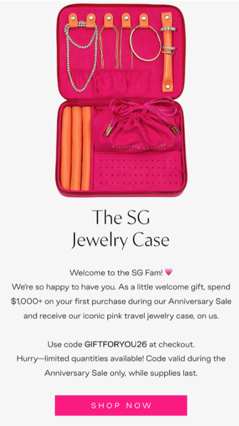 An email from high-end jewelry brand Stephanie Gottlieb, featuring a hero image of a pink jewelry case that’s open and revealing several pieces inside, including a pearl necklace and white and yellow gold necklaces and bracelets. Underneath is a welcome message with a code to receive the case after spending $1,000 on jewelry during their anniversary sale. Underneath the copy there is a pink CTA button that says, “Shop Now.”