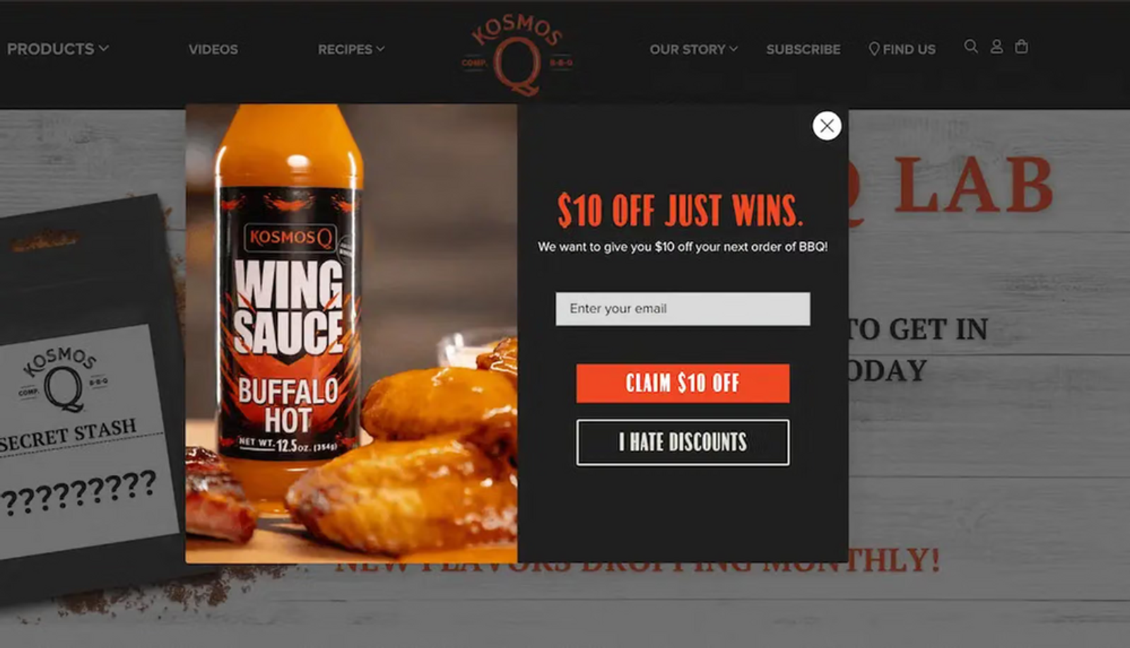 Image shows second page of a multi-step sign-up form from Kosmo’s Q, which asks users to agree to an offer before revealing they must provide their email address in order to claim their discount. On the left is a product shot of a bottle of orange wing sauce sitting on a table among several orange saucy chicken wings.