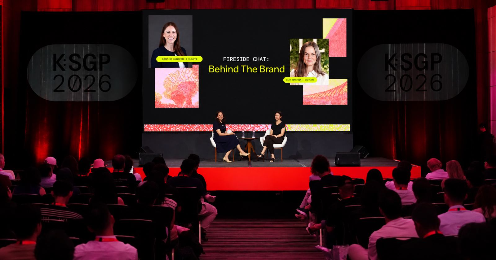 Two women on stage at a KSGP 2026 conference present a "Fireside Chat: Behind The Brand" to an audience.