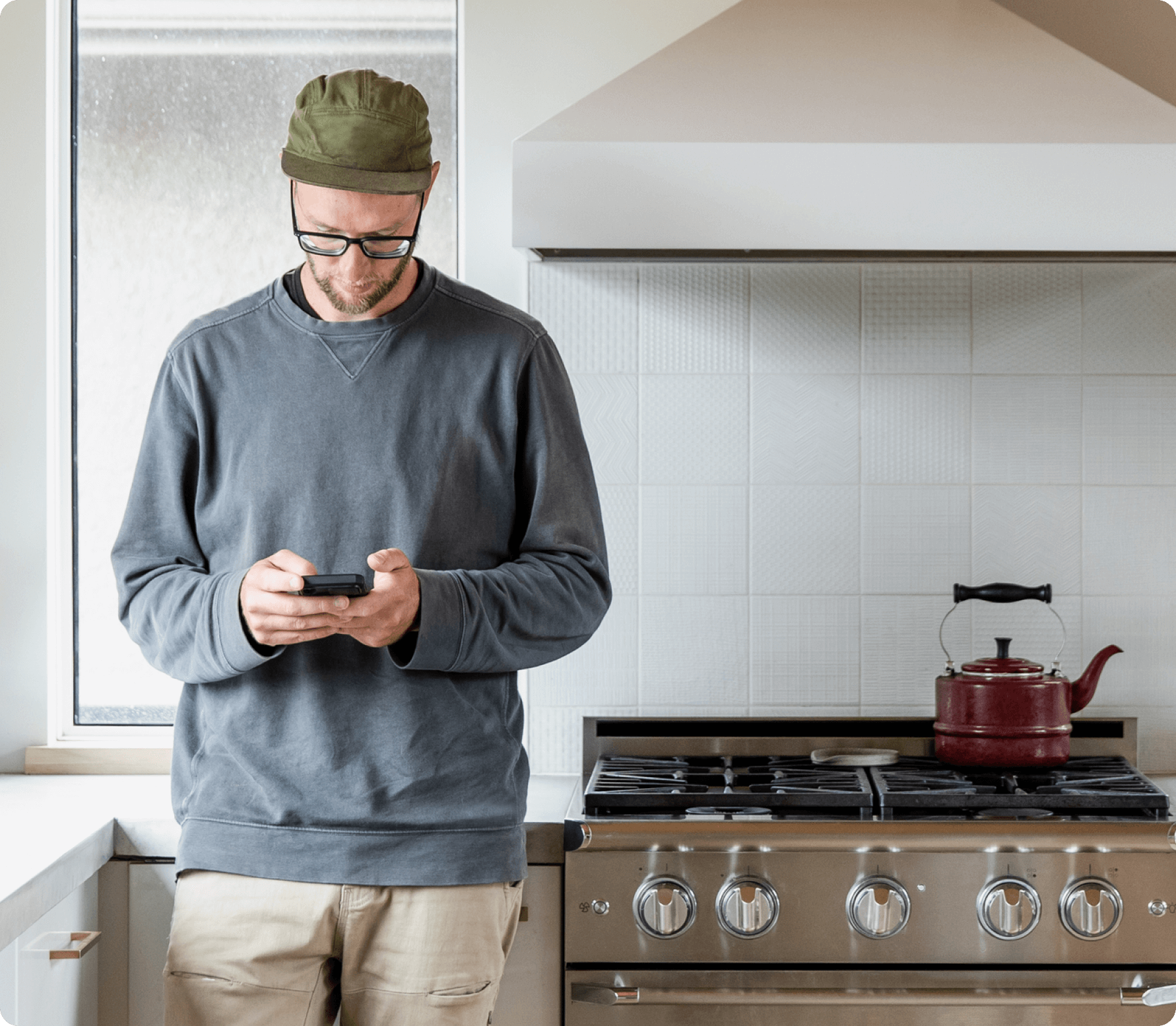 A photograph of a man looking at his phone.