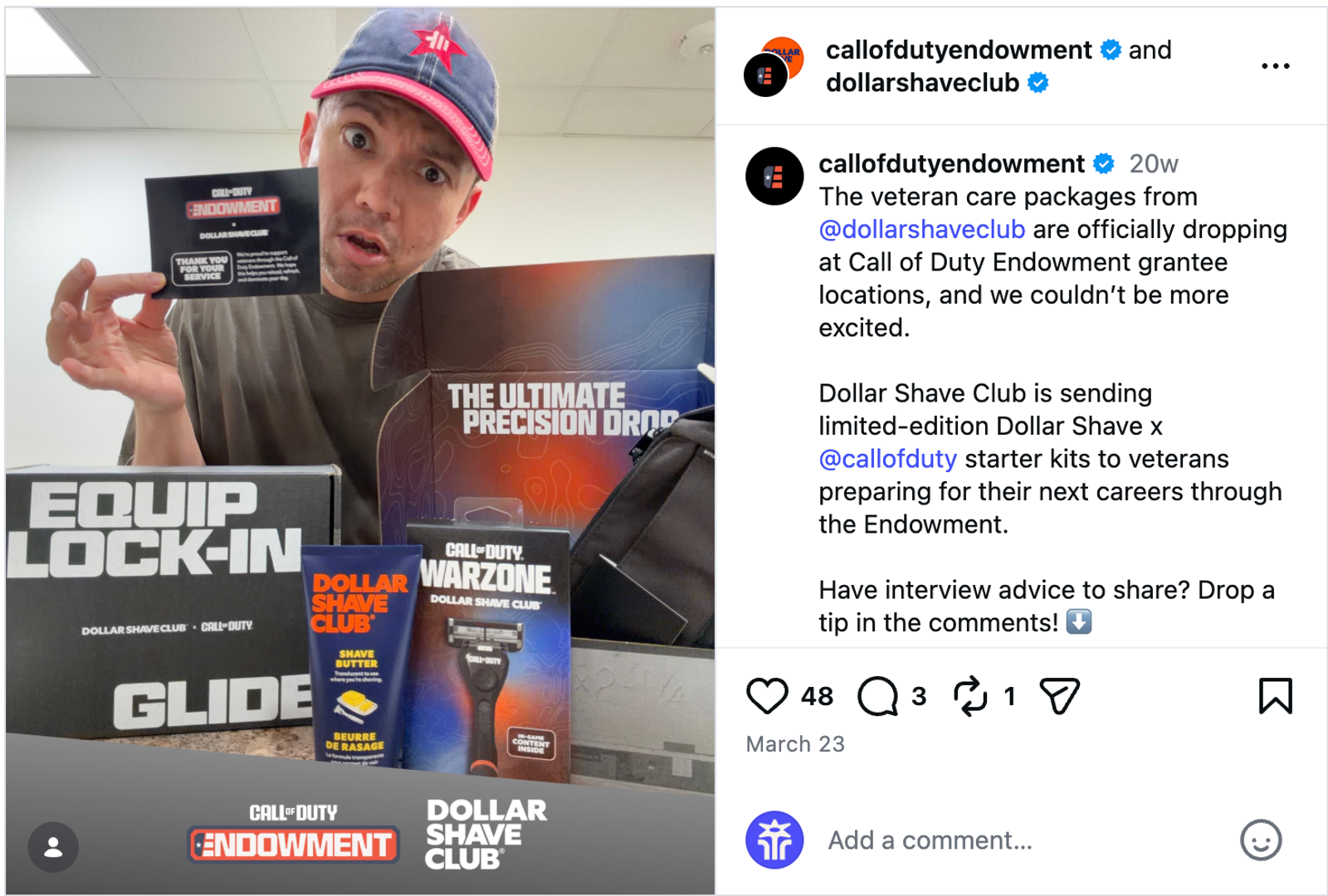 An Instagram post from Dollar Shave Club in partnership with the Call of Duty Endowment. The image features a person with light skin and dark facial hair stubble wearing a red and navy baseball cap, smiling and holding up a black card that reads, “Call of Duty Endowment x Dollar Shave Club: Thank you for your service.” In front of them sits an open Dollar Shave Club x Call of Duty branded box labeled, “The Ultimate Precision Drop.” The box contains grooming products, including a tube of shave butter and a razor featuring Call of Duty: Warzone branding in red, white, and blue as gradient colors. The post caption, from the Call of Duty Endowment, highlights that these veteran care packages are being sent to veterans preparing for their next careers through the endowment and asks followers to share interview tips in the comments.