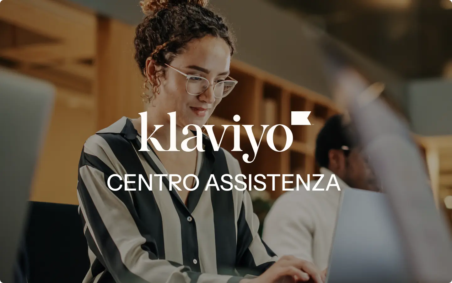Donna con occhiali lavora al computer, logo Klaviyo e testo "Centro Assistenza" sovrapposti.