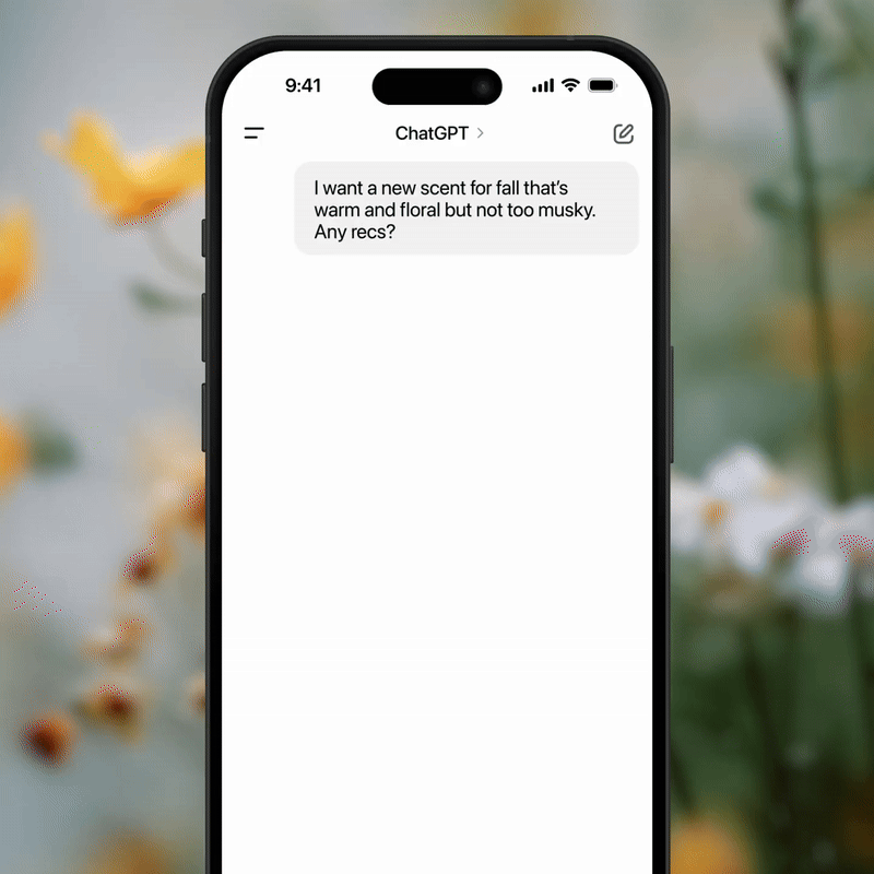 Smartphone screen showing a ChatGPT conversation about finding a warm, floral fall scent.