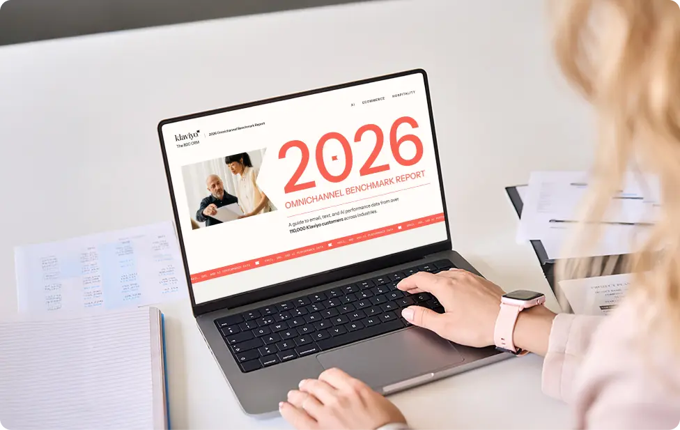 Person using a laptop displaying the "2026 Omnichannel Benchmark Report" by Klaviyo.