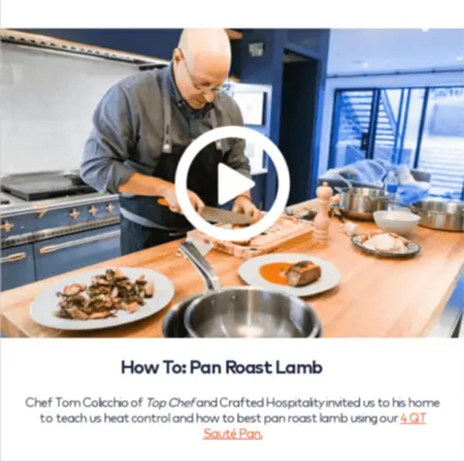 Image of a bald, light-skinned person wearing a navy blue apron cutting cooked lamb on a wooden cutting board with a large knife. On top of the image is a play button, to indicate that clicking on the image will take someone to a video. Underneath the image, text reads, “How To: Pan Roast Lamb.”