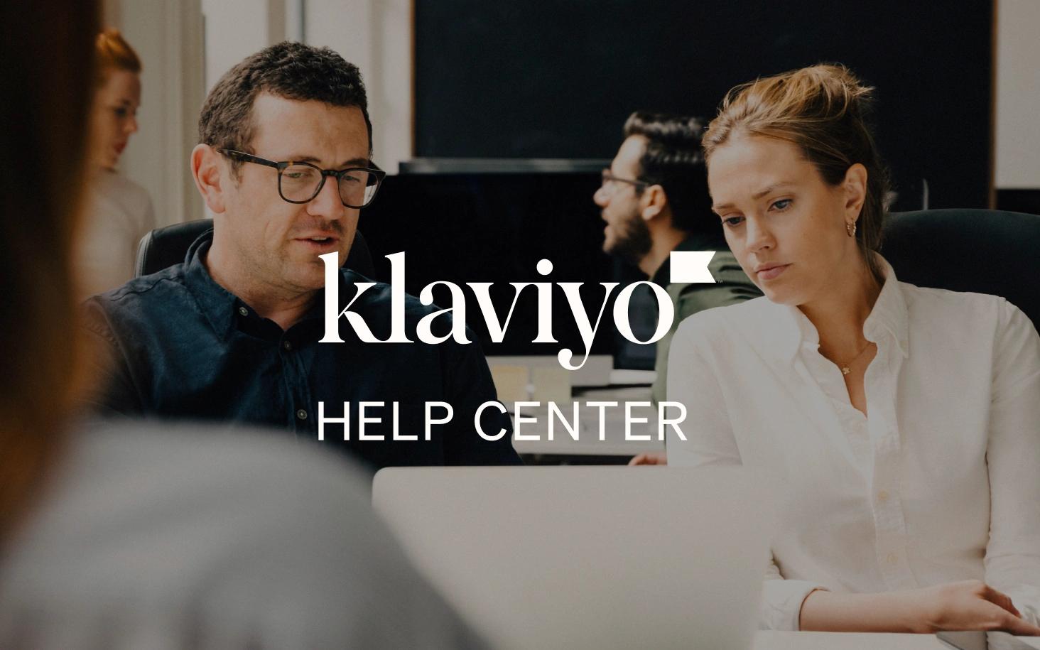 Two coworkers looking at a laptop in an office, overlaid with the Klaviyo Help Center logo.
