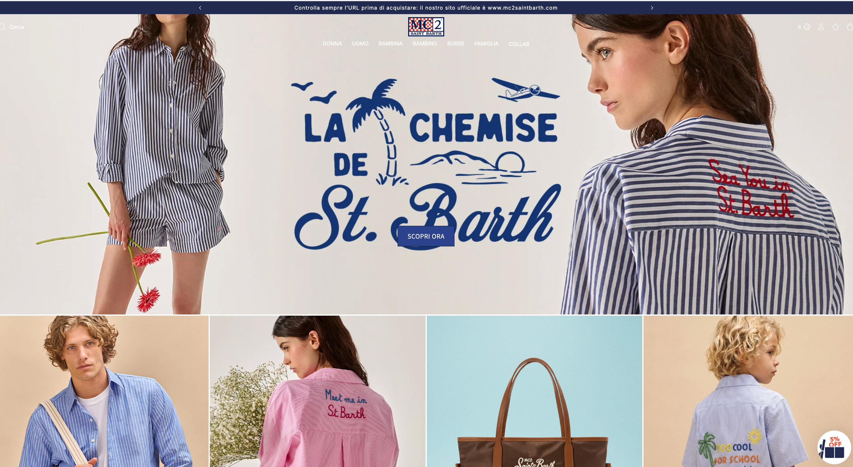 A screenshot of the MC2 Saint Barth e-commerce homepage. The main hero banner features a light beige background with two female models wearing blue and white striped button-down shirts and shorts. In the center, a large blue graphic illustration shows a palm tree, a small airplane, and the sun, accompanied by the stylized text "LA CHEMISE DE St. Barth" and a navy blue button that says "SCOPRI ORA" (Discover Now). One model's shirt features red embroidery on the back that reads "Sea You in St. Barth." Below the main banner is a grid of four smaller images: First: A male model in a blue striped shirt. Second: A female model in a pink striped shirt with red "Meet me in St. Barth" embroidery. Third: A brown tote bag with white branding. Fourth: A young boy in a blue striped shirt with colorful "Too Cool for School" embroidery. The top navigation menu includes categories like Donna, Uomo, Bambina, Bambino, Borse, Famiglia, and Collab. A thin dark blue bar at the very top provides a security reminder about the official website URL.