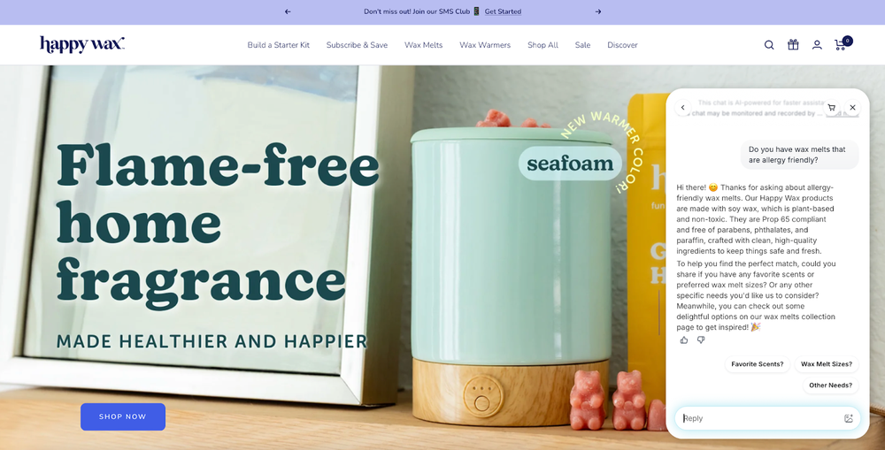 Screenshot of a conversation between a shopper and an AI agent on Happy Wax’s website. The shopper is asking which products are allergy friendly, and the AI agent gives a detailed answer about the product’s ingredients while also asking whether the customer has a preference for fragrance and size. To the left of the chat window is the Happy Wax hero banner, which shows a cylindrical wax warmer in seafoam green. Beside the wax warmer are two light red scented wax melts in the shape of gummy bears. The headline overlaid on top of the image reads, “Flame-free home fragrance, made healthier and happier.”