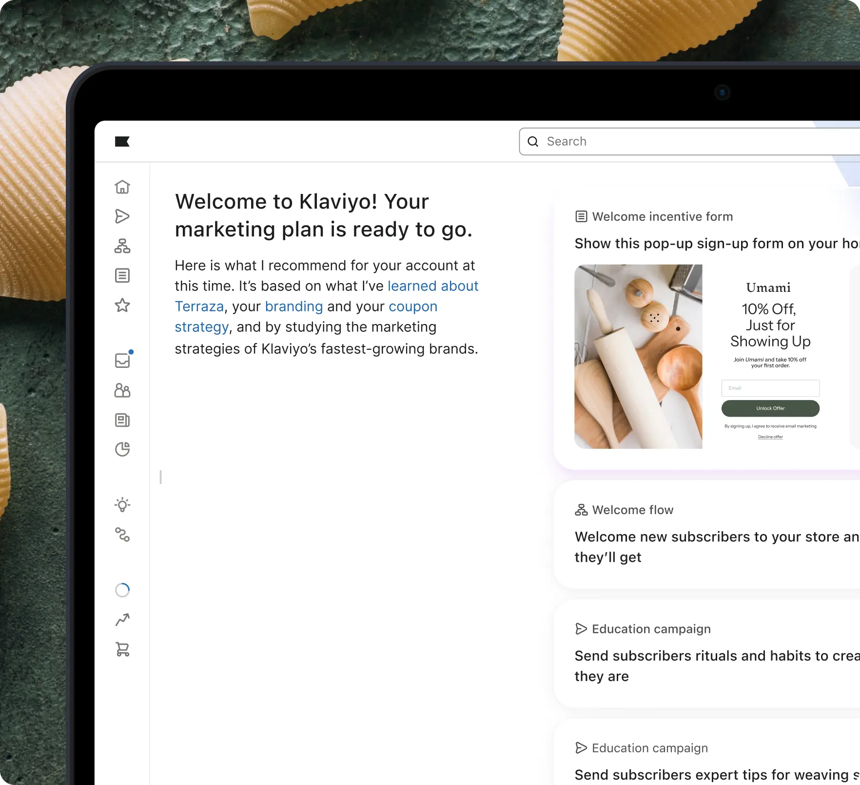 Laptop screen showing a Klaviyo marketing dashboard with a welcome message and marketing plan suggestions.