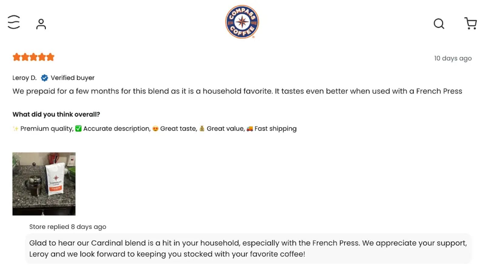 Image shows a screenshot of the Compass Coffee website, with a 5-star review from a customer for their Cardinal blend. The review reads, “We prepaid for a few months for this blend as it is a household favorite. It tastes even better when used with a French Press.” The review includes a photo of the product in the customer’s kitchen, and a response from the brand that reads, “Glad to hear our Cardinal blend is a hit in your household, especially with the French Press. We appreciate your support Leroy and we look forward to keeping you stocked with your favorite coffee!”