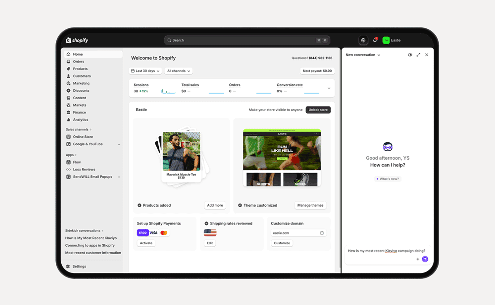 A laptop screen displaying the Shopify admin dashboard, featuring an overview of sales data, product images, and a customer support chat window.