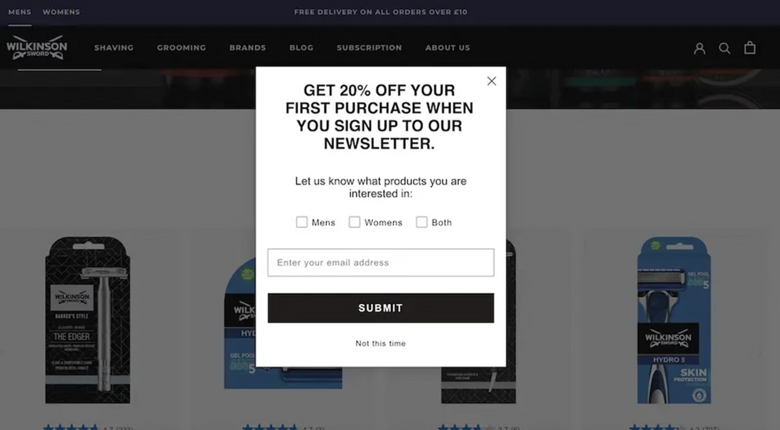 Image shows a pop-up form from Wilkinson Sword, offering 20% off in exchange for an email address, and allowing subscribers to select whether they’re interested in men’s products, women’s products, or both. In the background, faded out on the website proper, are several product shots of boxes of razors in blue and black.