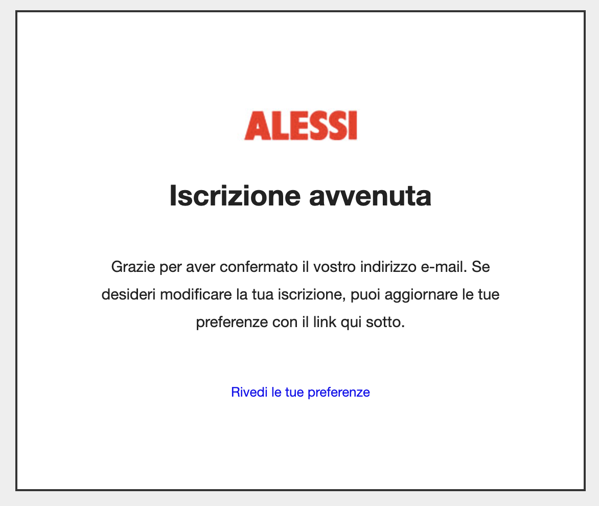 A confirmation message in Italian centered on a white background with a thin grey border. At the top is the ALESSI logo in red bold text. Below the logo, a large heading reads "Iscrizione avvenuta" (Registration successful). The body text thanks the user for confirming their email address and mentions they can update their preferences using the link below. At the bottom, a blue hyperlink reads "Rivedi le tue preferenze" (Review your preferences).