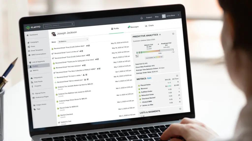 an image of a laptop open with a person working on it and a Klaviyo account in on the screen