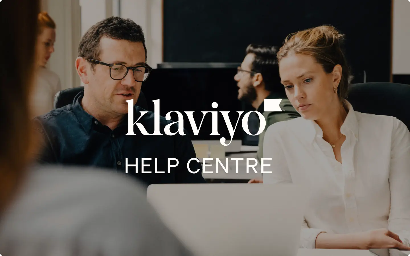 People working at computers with "Klaviyo Help Centre" text overlay.