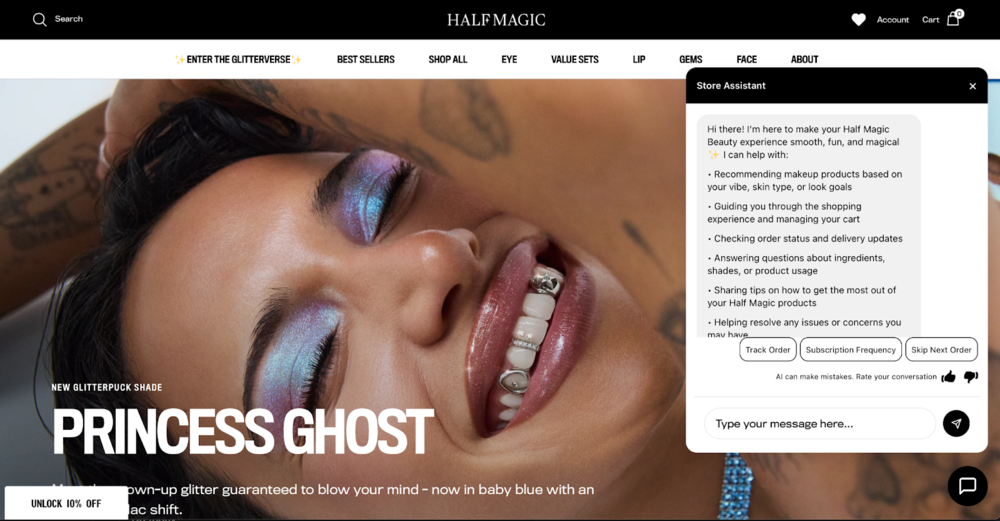 Screenshot of Half Magic’s AI agent on their branded homepage. There is a hero image of a close-up of a person with dark hair and a wide smile with diamonds embedded in their white teeth. The person is closing their eyes, and you can see blue and purple glitter eyeshadow on their eyelids. On the right side of the screen there is a white chat window with a gray text bubble where the shopper can choose what they would like help with from the brand’s AI assistant.