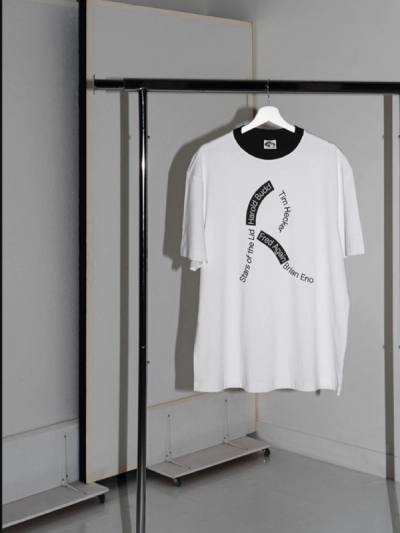 Rifugio Festival identity design – white t-shirt with curved artist lineup typography on clothing rack