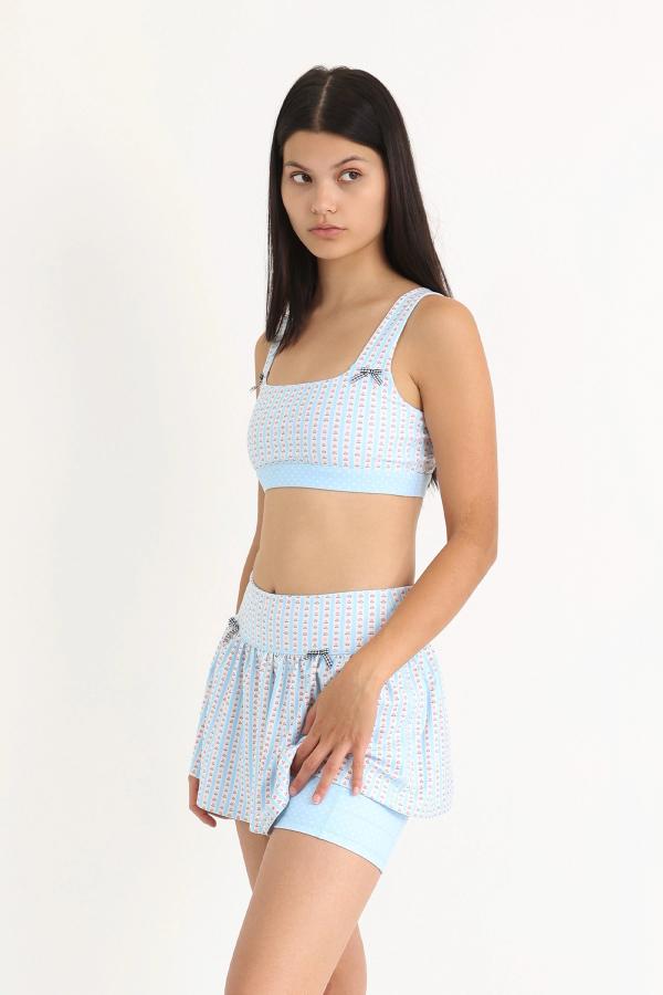 Gathered ruffle exercise skort in a hand-drawn, Blue/Ivory floral border stripe print with contrast black and white polka dot print and gingham bow details.