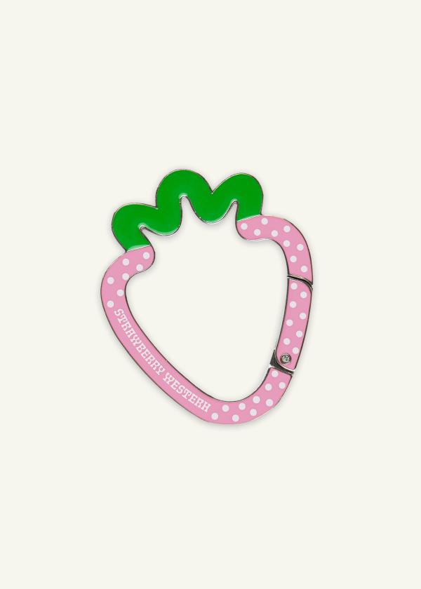 Strawberry shaped metal carabiner in pink and green enamel with white polka dots and Strawberry Western logo.