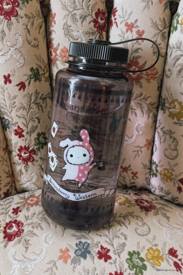 A special Sentimental Circus 32oz wide-mouth Sustain Nalgene water bottle in an eggplant purple. Artwork features Shappo the ringmaster and Kuro. Black cap and strap.