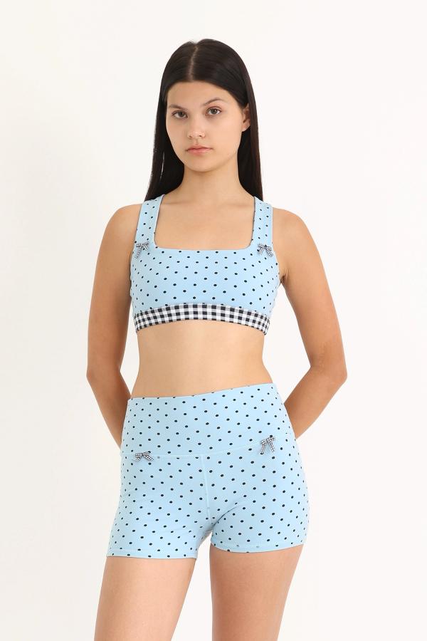 Front view of soft and supportive high-waisted yoga shorts with a fixed 3" inseam in a Blue Polka Dot print with gingham bows at the front.