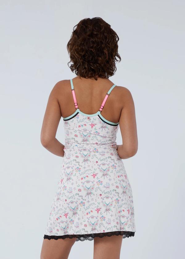 Back view of woman standing with arms bent in front of her wearing an exercise slip dress in a fairy-like starbaby print with a black lace trim at hem, mint binding chest and hot pink adjustable shoulder straps. 